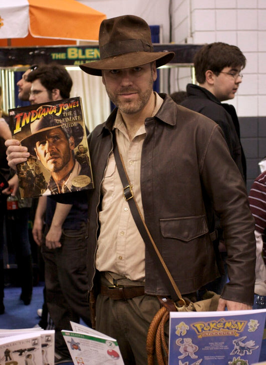 Cosplayer dressed as Indiana Jones in his brown fedora and leather jacket