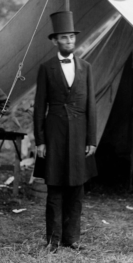 Abraham Lincoln standing in his black stovepipe top hat, 1862